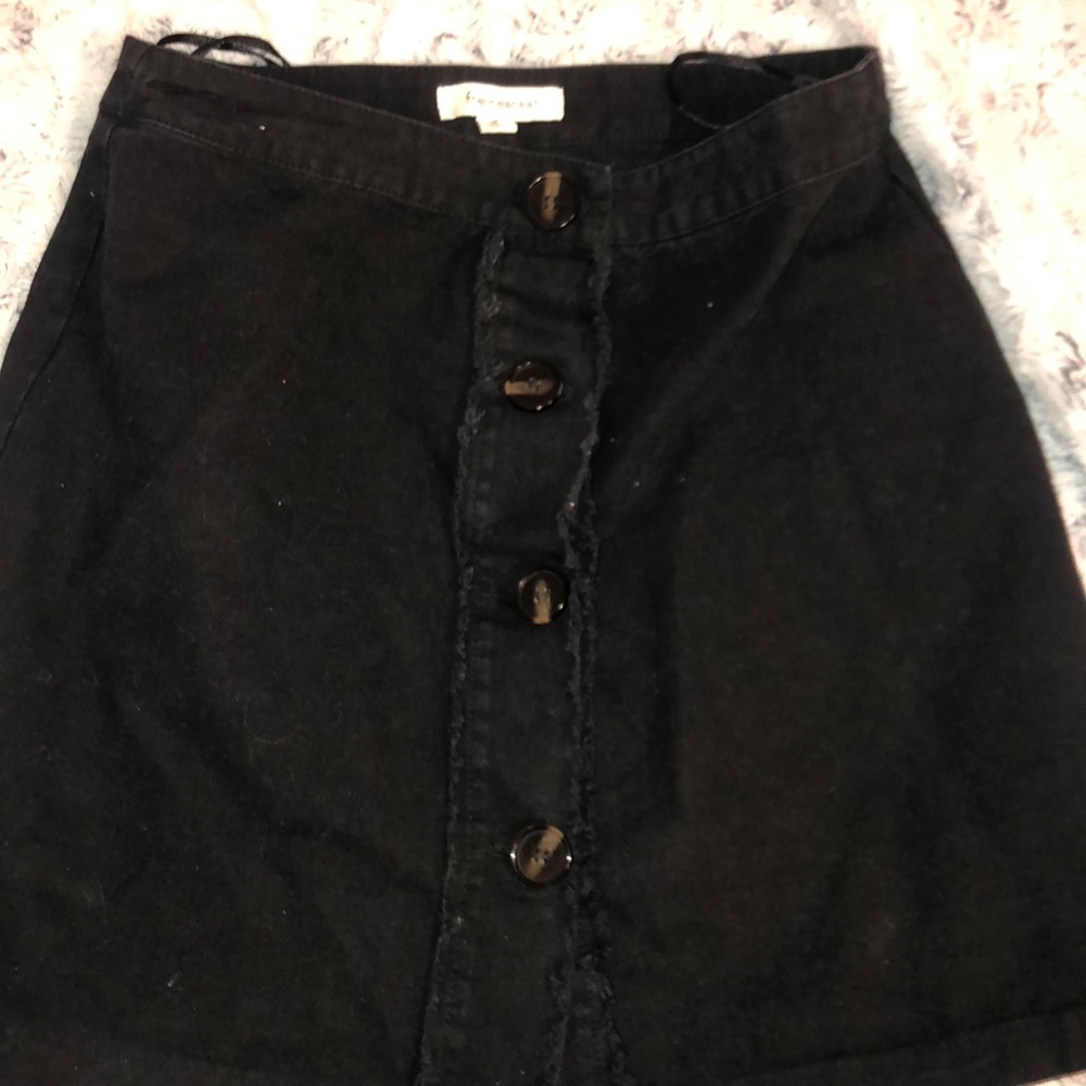 black skirt with tortoiseshell buttons